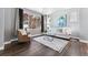 Cozy living room with large window, stylish decor, comfortable seating and hardwood floors at 6771 Canosa St, Denver, CO 80221