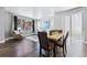 Open-concept living room with hardwood floors, natural light, and a dining area at 6771 Canosa St, Denver, CO 80221