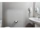 Clean powder room with pedestal sink and toilet at 6771 Canosa St, Denver, CO 80221