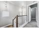 Upstairs hallway with light fixtures and staircase at 6771 Canosa St, Denver, CO 80221