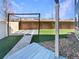 Backyard features an artificial lawn, stone paver pathway, a wood deck, and a pergola at 5470 Danube St, Denver, CO 80249