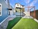 Landscaped backyard featuring artificial grass, pergola, and privacy fencing at 5470 Danube St, Denver, CO 80249