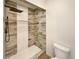 Walk-in shower showcasing detailed tilework and a rainfall showerhead at 5470 Danube St, Denver, CO 80249