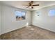Cozy bedroom features a ceiling fan, plush carpeting and sunny windows at 5470 Danube St, Denver, CO 80249