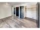 Bedroom features wood-look floors, ample closet space, and modern black doors at 5470 Danube St, Denver, CO 80249