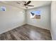 Bedroom with engineered wood floors, a ceiling fan, and bright, sunlit windows at 5470 Danube St, Denver, CO 80249