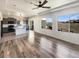 Bright open-concept living space with wood-look flooring, modern kitchen, and plenty of natural light at 5470 Danube St, Denver, CO 80249
