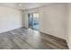This open living space offers wood-look flooring and sliding glass doors for easy outdoor access at 5470 Danube St, Denver, CO 80249