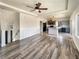 This open-concept living space features wood-look flooring and transitions into the modern kitchen at 5470 Danube St, Denver, CO 80249