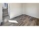Bright living room features wood-look flooring and leads to an adjacent staircase, creating an inviting atmosphere at 5470 Danube St, Denver, CO 80249