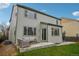 Rear exterior showing the home's patio, garden, and large windows at 60 Stewart Way, Erie, CO 80516