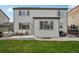 Rear exterior showing the home's patio, yard, and many windows at 60 Stewart Way, Erie, CO 80516