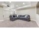 Spacious basement with recessed lighting and comfortable sectional sofa at 60 Stewart Way, Erie, CO 80516