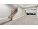 Finished basement with carpet, stairs, and an entertainment area with a sectional at 60 Stewart Way, Erie, CO 80516
