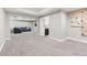 Finished basement area with a sectional, climbing wall, and a half bath at 60 Stewart Way, Erie, CO 80516