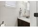 Bathroom featuring granite countertops, a sink, vanity, and a framed mirror at 60 Stewart Way, Erie, CO 80516