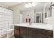 Neutral bathroom with large vanity, a shower-tub combo, and decorative shower curtain at 60 Stewart Way, Erie, CO 80516