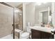 Bathroom with a glass-enclosed shower, seat, and modern fixtures at 60 Stewart Way, Erie, CO 80516
