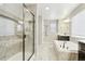 Luxurious bathroom featuring a glass shower, a soaking tub, and tile flooring at 60 Stewart Way, Erie, CO 80516