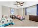 Inviting bedroom with two beds, ceiling fan, and window with blinds at 60 Stewart Way, Erie, CO 80516