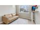 Bedroom featuring a comfortable sofa, a modern desk, and a bright window view at 60 Stewart Way, Erie, CO 80516