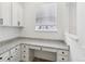 Functional kitchen nook with granite countertops, white cabinets, and a bright window at 60 Stewart Way, Erie, CO 80516