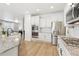 Bright kitchen with stainless steel appliances, granite countertops, and light wood flooring at 60 Stewart Way, Erie, CO 80516