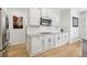 Modern kitchen features granite countertops, stainless steel appliances, and sleek white cabinetry at 60 Stewart Way, Erie, CO 80516