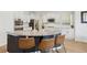 Spacious kitchen featuring a center island with bar seating and a granite countertop at 60 Stewart Way, Erie, CO 80516