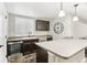 Kitchenette with breakfast bar, undermount sink, and stainless appliances at 60 Stewart Way, Erie, CO 80516
