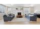 Elegant living room featuring a fireplace, built-in shelves, and large windows for natural light at 60 Stewart Way, Erie, CO 80516