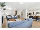 Spacious living area with hardwood floors connecting the kitchen, dining, and living spaces at 60 Stewart Way, Erie, CO 80516