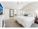 Bright main bedroom showcasing an electric fireplace and a view into the large attached bathroom at 60 Stewart Way, Erie, CO 80516