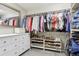 Organized walk-in closet with shelving, rods for hanging clothes, and a full length mirror at 60 Stewart Way, Erie, CO 80516