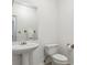 Clean half bathroom with pedestal sink, toilet, and neutral decor, offering a convenient and well-maintained space for guests at 2796 Newport Cir, Castle Rock, CO 80104