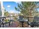 Outdoor deck with metal patio furniture surrounded by trees with a view of the neighborhood at 2796 Newport Cir, Castle Rock, CO 80104