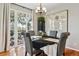 Dining room with table set for four, chandelier and access to outdoor deck at 2796 Newport Cir, Castle Rock, CO 80104