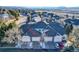 View of townhouse property showcasing its well-maintained facade, garages, and landscaping at 2796 Newport Cir, Castle Rock, CO 80104