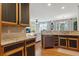 Open kitchen with stainless steel appliances, dark cabinets and a view of the living room at 2796 Newport Cir, Castle Rock, CO 80104