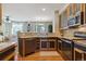 Modern kitchen with stainless steel appliances, wood cabinets and a view of the living room at 2796 Newport Cir, Castle Rock, CO 80104