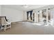 Bright living room with neutral carpet, ceiling fan, and sliding glass doors, creating a comfortable and inviting space at 2796 Newport Cir, Castle Rock, CO 80104