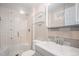 Bathroom features a glass-enclosed tub shower and modern sink with vanity at 10858 E Harvard Dr, Aurora, CO 80014