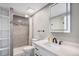Bathroom featuring gray tile shower with glass door and modern vanity at 10858 E Harvard Dr, Aurora, CO 80014