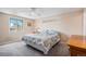 Comfortable bedroom with a ceiling fan, window, and carpeted floors at 10858 E Harvard Dr, Aurora, CO 80014