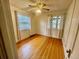 Bright bedroom featuring hardwood floors, a ceiling fan, and natural light through windows at 1881 S Lincoln St, Denver, CO 80210
