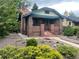 Charming brick home with a cozy front porch and colorful landscaping at 1881 S Lincoln St, Denver, CO 80210