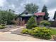 Beautiful brick home with a red roof and lush landscaping at 1881 S Lincoln St, Denver, CO 80210