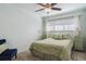 Cozy bedroom with natural light, ceiling fan, a queen bed, and matching accent pillows and bedside tables at 7255 S Vine St, Centennial, CO 80122