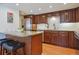 Modern kitchen featuring granite counters, stainless steel appliances, and a breakfast bar at 7255 S Vine St, Centennial, CO 80122