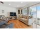 Bright living room with a comfortable couch and a sliding door access to the backyard at 7255 S Vine St, Centennial, CO 80122